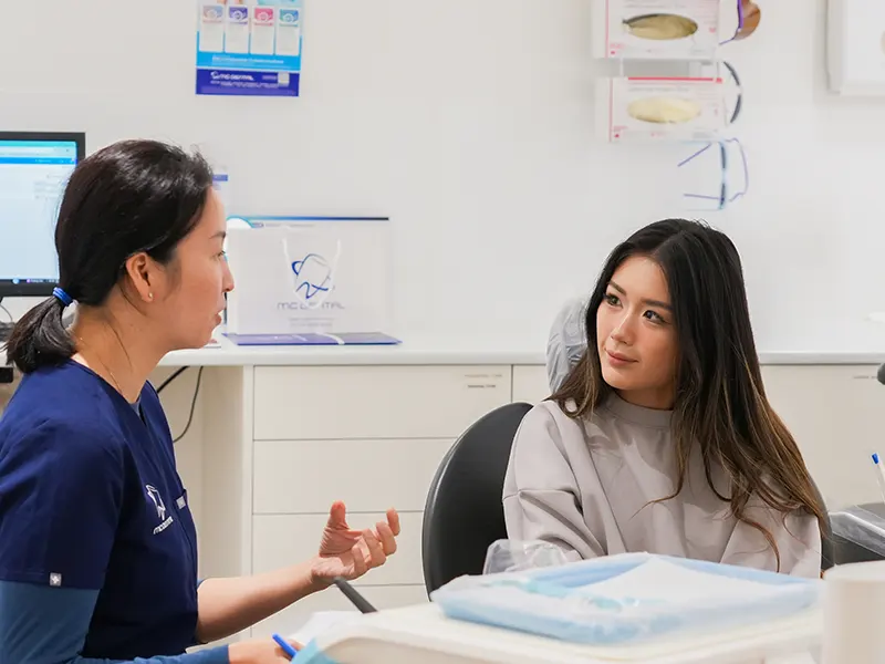 MC Dental dentist talking with patient MC Dental dentist talking with patient